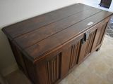 an image of a wooden chest in the corner of a room