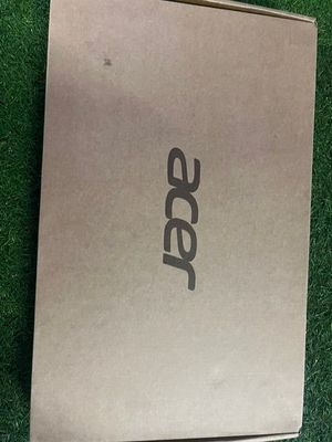 an open box of a laptop computer sitting on top of a lush green field
