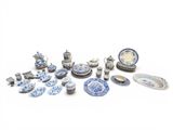 many pieces of blue and white pottery on the table