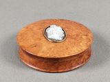 an image of a wooden box with a stone in the center