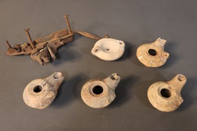several pieces of pottery sitting on top of a table next to a piece of wood