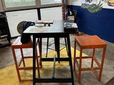 a small table and two stools in a room