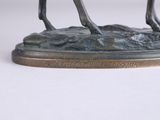 bronze statue of a horse with a rider on it ' s back
