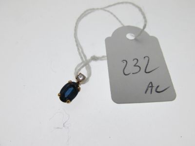 a tag with a blue stone on it that is attached to a string