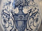 a blue and white pitcher with a floral design on it