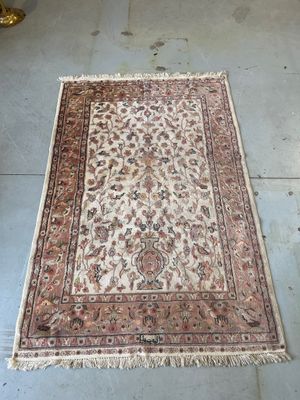 rug on the floor in a room with a chair and a table