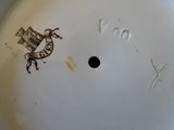 a white plate with a brown horse on it