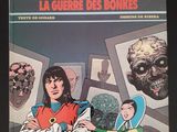 la couverture d'une bande dessinée sur laquelle figurent un homme et une femme debout devant une série de photos