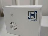 an electronic device sitting on top of a table next to a window