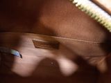 the inside of a brown purse with a zipper on the inside