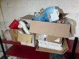 a pile of boxes on a red shelf in a room