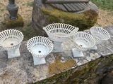 five white bowls sitting on a stone ledge