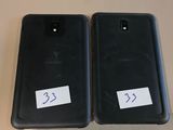 two black samsung s9 and s9e phones are sitting side by side on a table