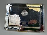 a silver tray with a picture on it on a table