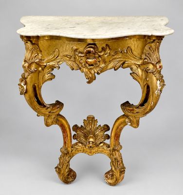 an ornately carved console table with marble top