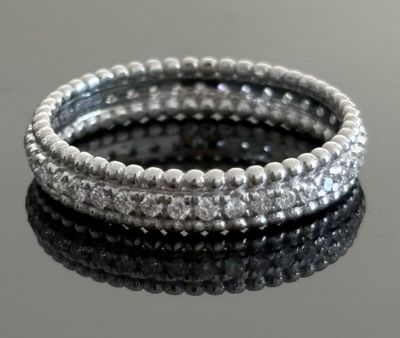 silver beaded stretch bracelets stacked on a black surface