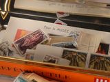 a suitcase with stamps on it and a stack of books