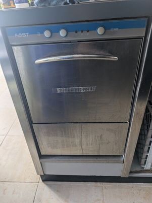 stainless steel dishwasher sitting on top of a counter in a kitchen
