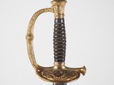 une épée ancienne dorée et noire, dotée d'une poignée en bois
