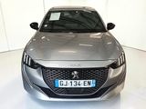 a silver car that is parked in a white room