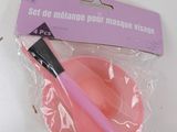 a plastic bowl with a pink brush inside of it