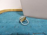 a ring that is sitting on the floor next to a purse