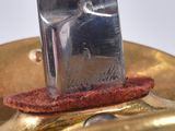 a knife that is sitting on top of a gold plate