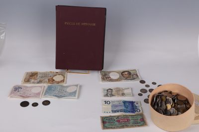 a box of coins and a book on a table