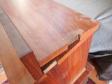 a wooden table with a drawer on top of it