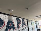 a sign that says papa on the side of a brick wall