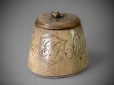 a small wooden box with writing on it on a table