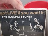 a person holding a stack of records on a table
