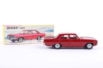 a red toy car sitting next to a boxed box