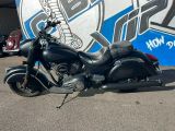 une moto noire garée devant un immeuble recouvert de graffitis