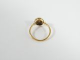 a close up of a gold ring with a stone in it