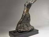 a bronze sculpture of a dog on a black base