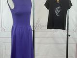 purple and black dress on display in a room with white walls