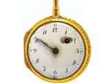 a gold pocket watch with a chain hanging from it ' s side