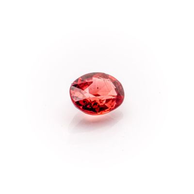 a close up view of a red diamond on a white surface