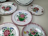 many plates with flowers on them on a table
