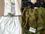 trois vêtements posés sur une boîte en carton