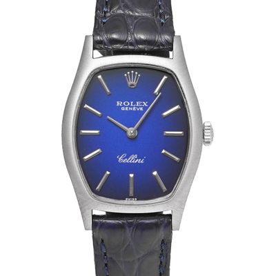 a close up of a wrist watch with a blue dial