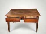 an old wooden desk with two drawers on top of it