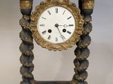 a black and gold clock sitting on a table