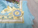 a blue and gold bed spread with a pillow and a pillow case