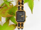 a black and gold watch with a chain around it