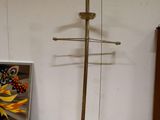 a metal object on a wooden table next to a painting