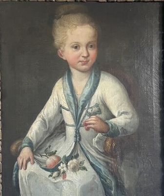 portrait of a young boy in a white dress and blue scarf