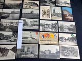 a lot of old black and white photos on the table