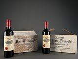 two bottles of wine are sitting next to a box of wine